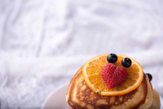 Pancakes with berries and maple syrup