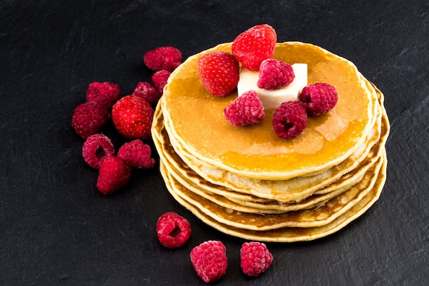 Pancakes with berry fruit and honey. Selective focus