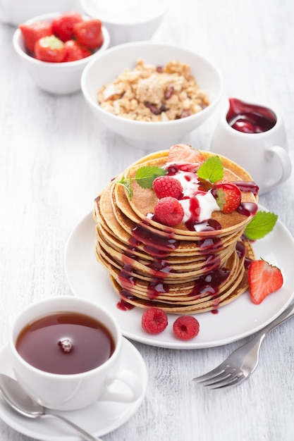 Pancakes with berry and jam for breakfast