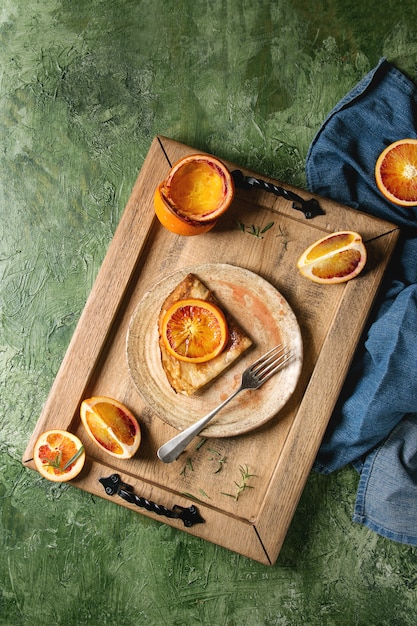 Pancakes with bloody oranges