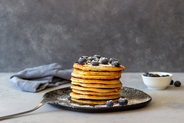 Pancakes with blueberries and honey. Breakfast. Vegetarian food. Recipe.