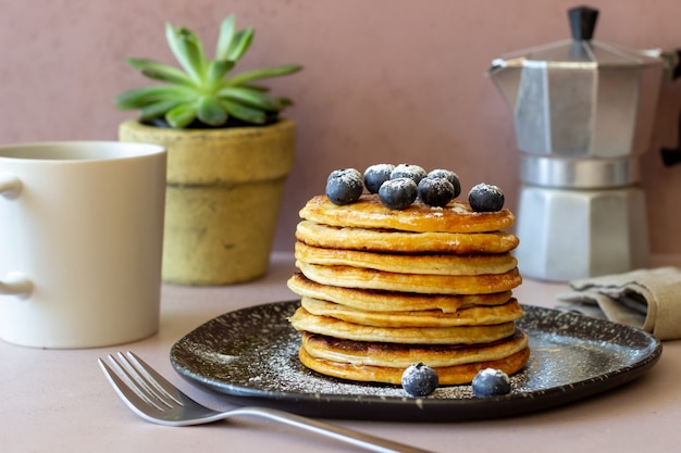 Pancakes with blueberries and honey. Breakfast. Vegetarian food. Recipe.