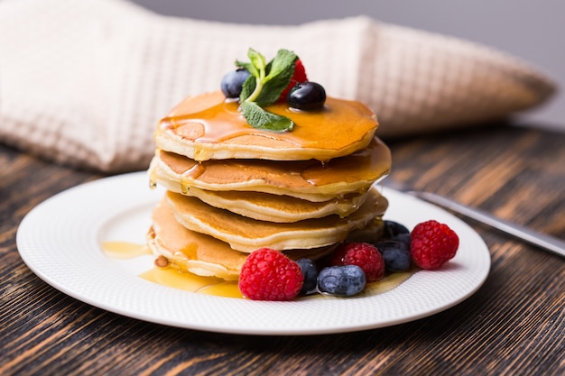 Pancakes with blueberries and raspberry on a plate