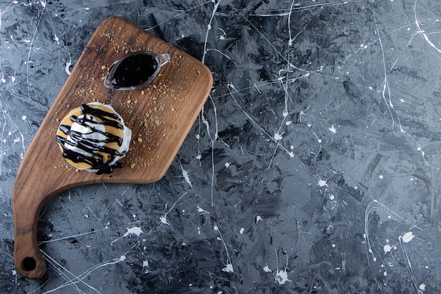 Pancakes with chocolate topping and whipped cream on wooden board. 