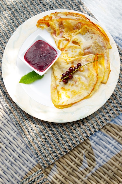 Pancakes with currant berries and jam