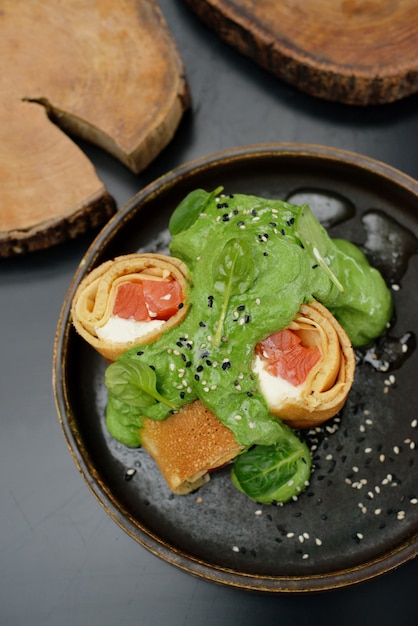 Pancakes with fish salmon, cheese and spinach. Restaurant menu