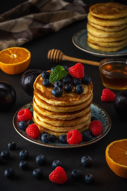 Pancakes with fresh berries and honey