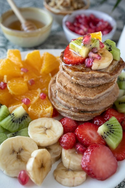 Pancakes with fresh fruit. Fruit salad with gluten-free pancakes. Healthy breakfast full of vitamins