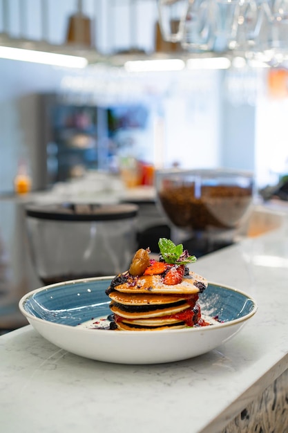 Pancakes with fruits stacked