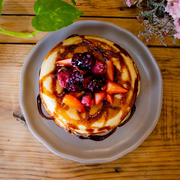 Pancakes with fruits and syrup