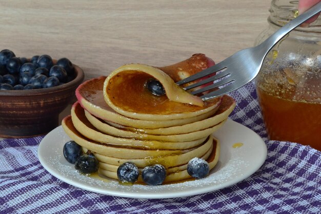 pancakes with honey are eaten with a fork