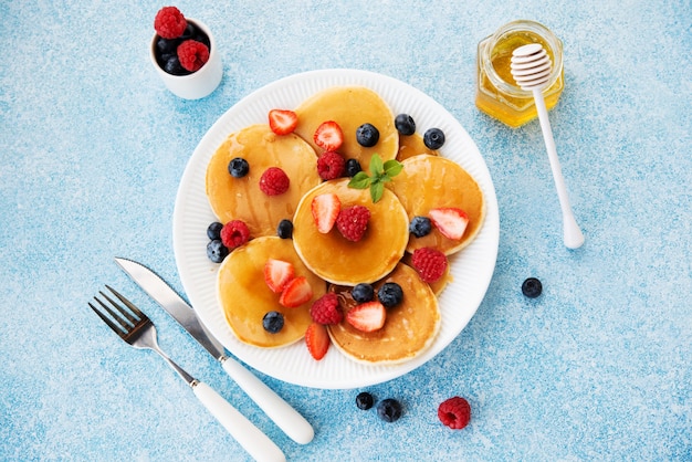 Pancakes with honey and berries