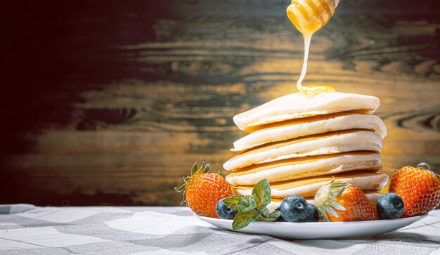 Pancakes with honey and fruit