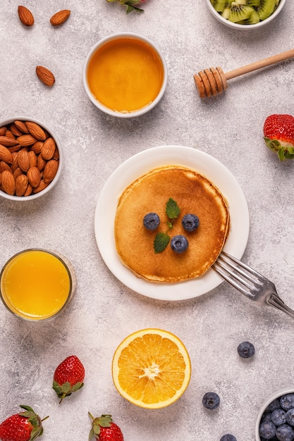 pancakes with honey, fruits and nuts