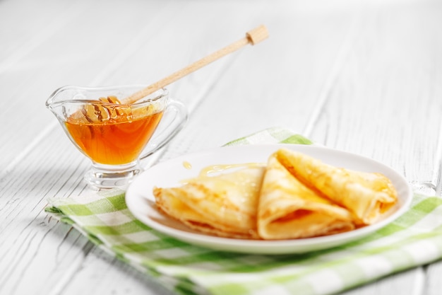 Pancakes with honey on the table