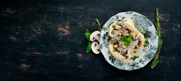 Pancakes with mushrooms cheese and cream sauce On a wooden background Top view Free space for your text