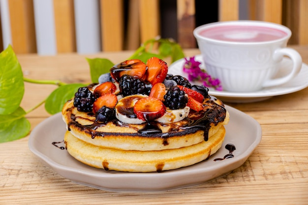 Pancakes with pink smoothie in background