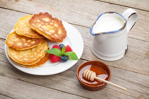 Pancakes with raspberry blueberry milk and honey syrup