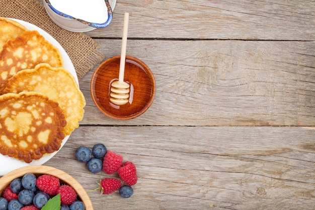 Pancakes with raspberry blueberry mint and honey syrup