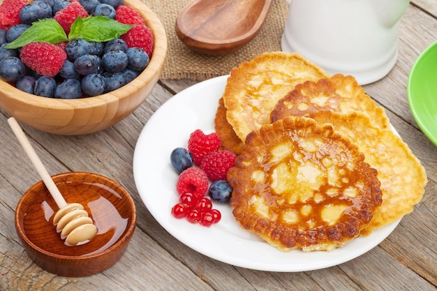 Pancakes with raspberry blueberry mint and honey syrup