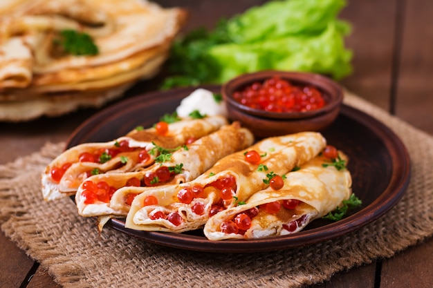 Pancakes with red caviar and cream cheese