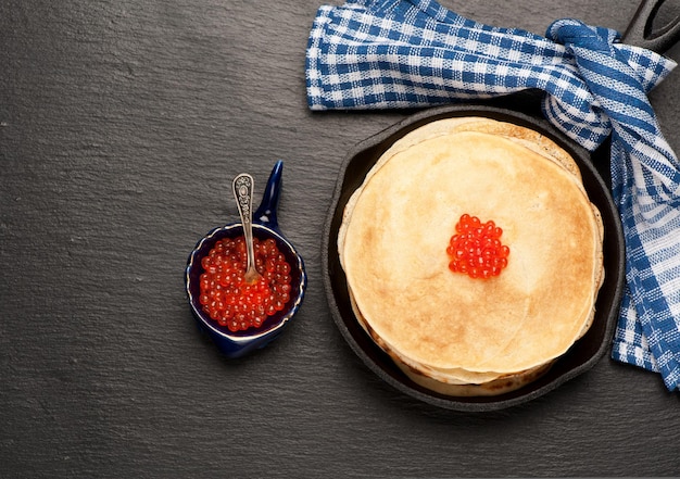 Pancakes with red caviar top view