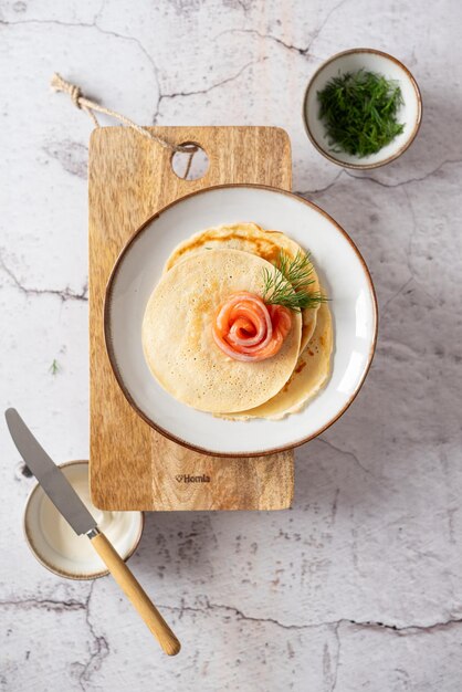 Photo pancakes with salmon and sour cream