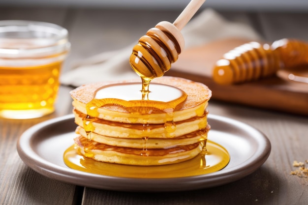 Pancakes with a spoonful of honey on the side