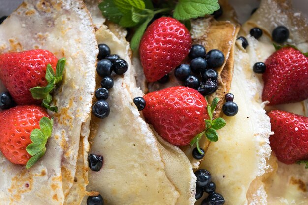 Pancakes with strawberries blueberries closeup view Pancakes