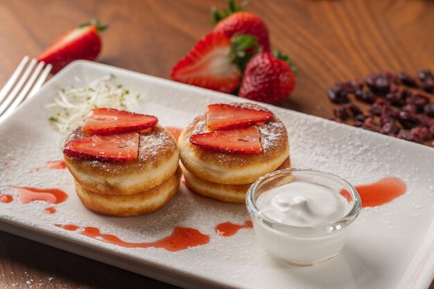 Pancakes with strawberry and jam on plate