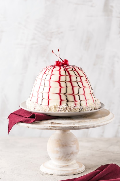 Pancho cake with cherry filling on a wooden stand closeup