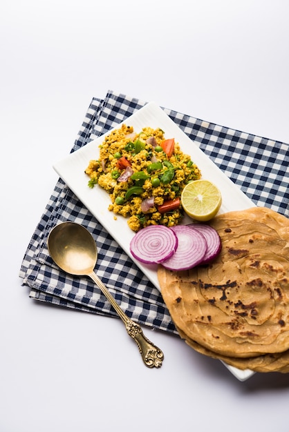 Paneer Bhurji, mildly spiced cottage cheese scramble and served with roti or laccha paratha, selective focus