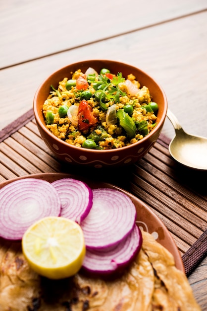 Paneer Bhurji, mildly spiced cottage cheese scramble and served with roti or laccha paratha, selective focus