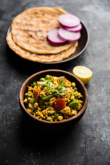 Paneer Bhurji, mildly spiced cottage cheese scramble and served with roti or laccha paratha, selective focus