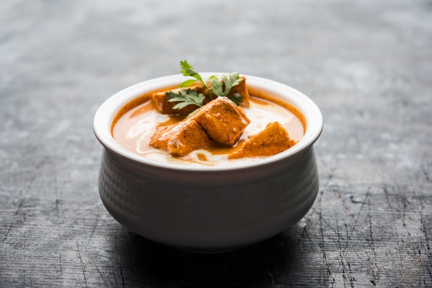 Paneer Butter Masala also known as Panir  makhani or makhanwala. served in a ceramic or terracotta bowl with fresh cream and coriander.selective focus