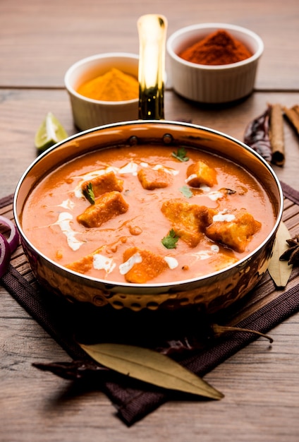 Paneer Butter Masala or Cheese Cottage Curry in serving a bowl or pan, served with or without roti and rice