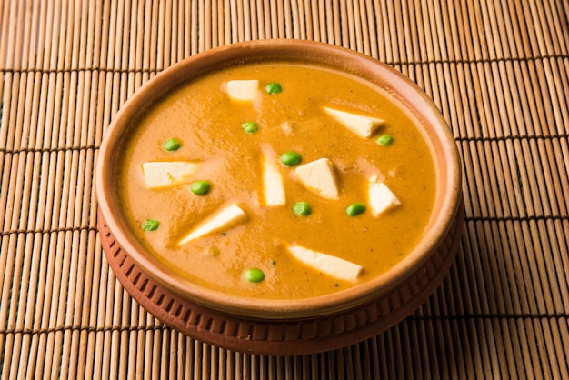 Paneer Butter Masala is famous indian food recipe made using cottage cheese, served in a bowl. selective focus