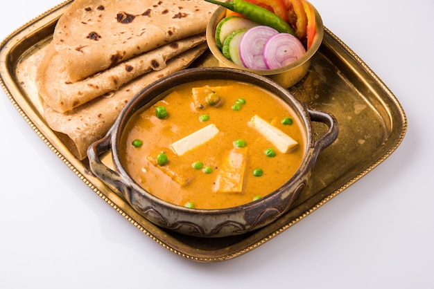 Paneer Butter Masala is famous indian food recipe made using cottage cheese, served with flat bread also known as roti or chapati. selective focus