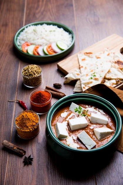 Paneer Butter Masala is a popular North Indian recipe for lunch or dinner made using cottage cheese in red tomato curry. usually served with Rice and chapati or naan. selective focus