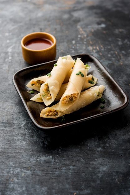 Paneer chilli cigar are crispy rolls stuffed with paneer which is an interesting starter for any party. served with tomato ketchup. selective focus