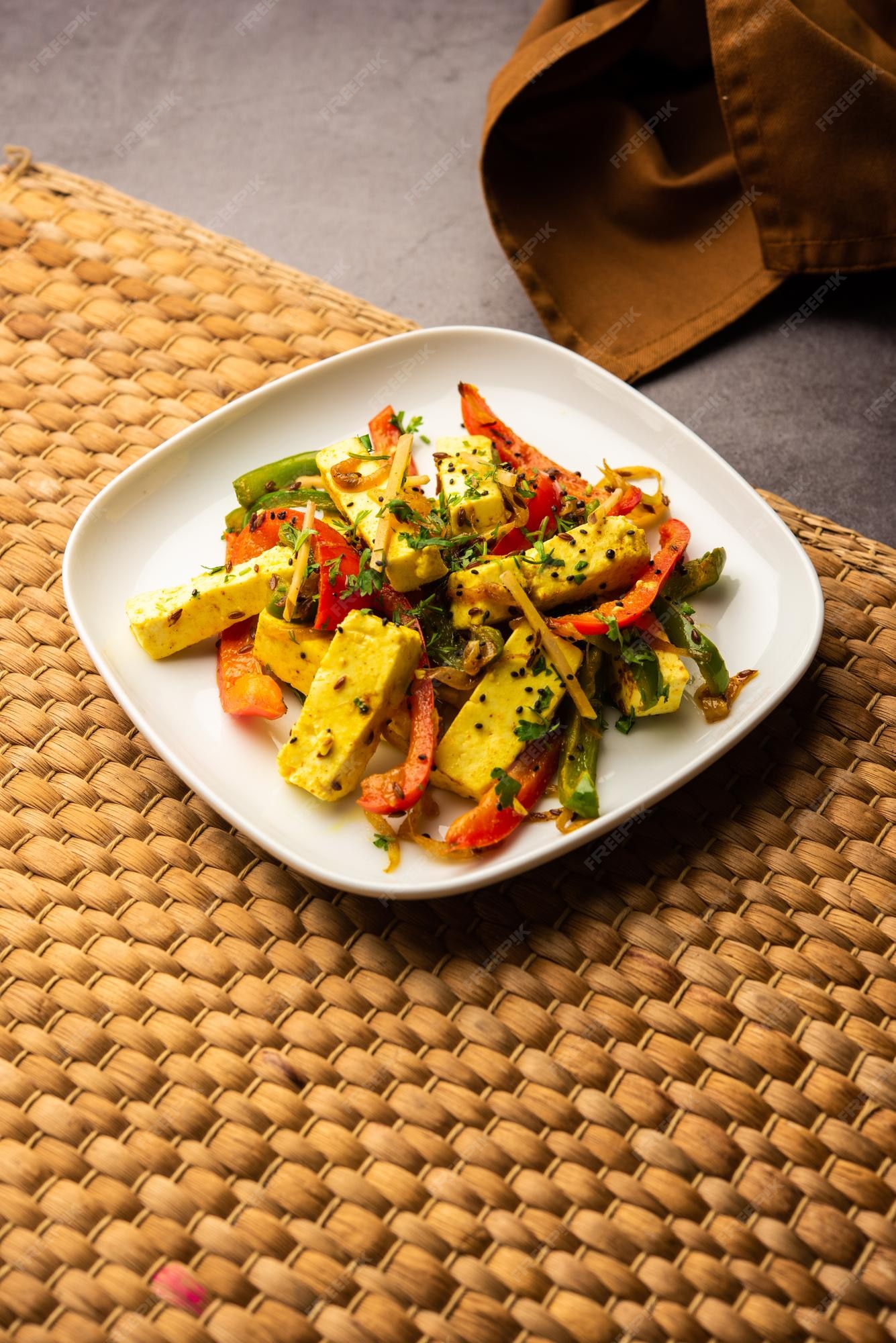 Premium Photo | Paneer jalfrezi cottage cheese cooked with peppers and ...