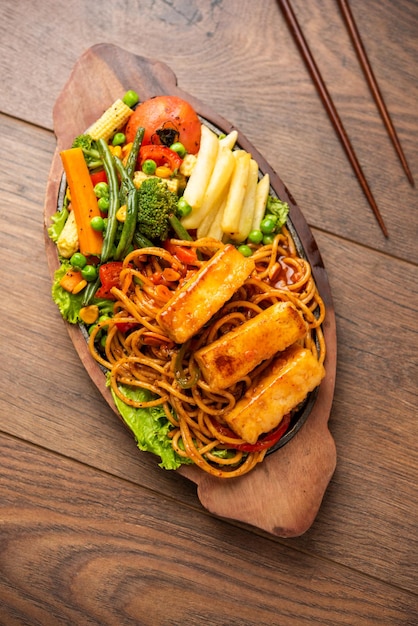 Paneer Sizzler is an Indian version with cottage cheese salad served sizzling on hot stone dish