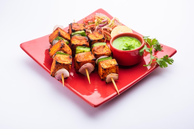 Paneer tikka is an Indian dish made from chunks of cottage cheese marinated in spices and grilled in a tandoor