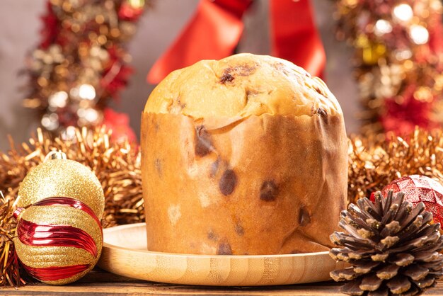 Panettone panettone with chocolate flavors on a rustic table with christmas decorations selective focus