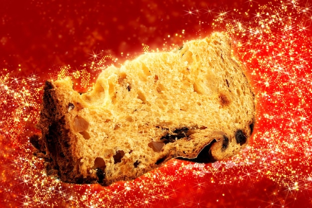 Panettone with sliced traditional christmas food piece with red background