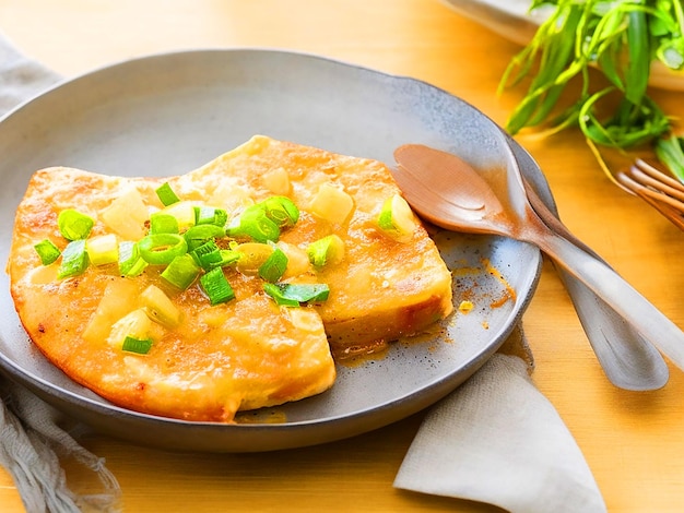 panfried luncheon meat cubes on omelets on top of a rustic shallow bowl of rice