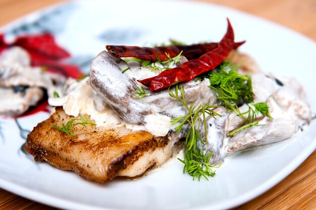 Pangasius fillet in cream sauce with mushrooms