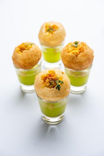 Panipuri shot or Golgappa Shots different flavours of water served in small glasses with stuffed puri Indian starter snack