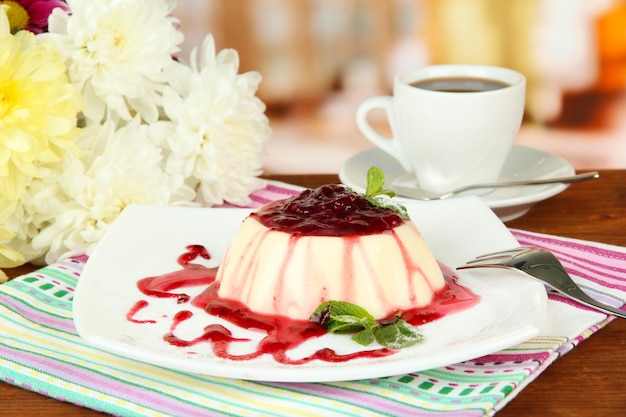 Panna Cotta with raspberry sauce on bright background