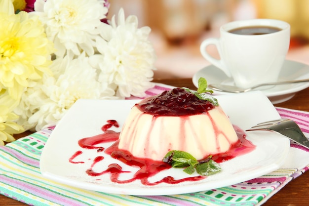 Panna Cotta with raspberry sauce on bright background